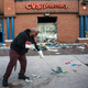 Jerald Miller helps clean up debris April 28, 2015, from a CVS pharmacy in Baltimore that was set on fire during unrest following the funeral of Freddie Gray the day before. The CVS was one of several businesses damaged. Because it’s part of corporate chain, it will be rebuilt quickly. The same might not be true for black-owned businesses.
Andrew Burton/Getty Images